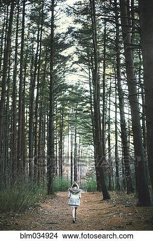 Caucasian woman walking on dirt path in forest View Large Photo Image Picture - Caucasian woman walking on dirt path in forest. Fotosearch