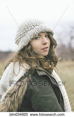 Stock Image - Caucasian woman wearing knitted cap. Fotosearch