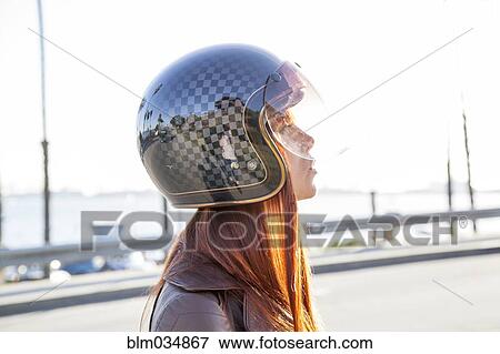 Caucasian woman wearing motorcycle helmet View Large Photo Image Stock Photo - Caucasian woman wearing motorcycle helmet. Fotosearch