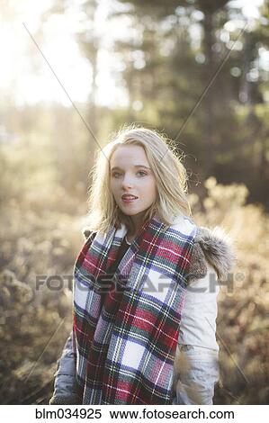 Stock Photography - Caucasian woman wearing scarf in forest. Fotosearch
