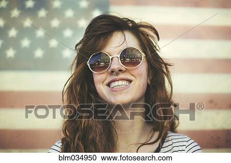Caucasian woman wearing sunglasses at American flag View Large Photo Image Stock Image - Caucasian woman wearing sunglasses at American flag. Fotosearch