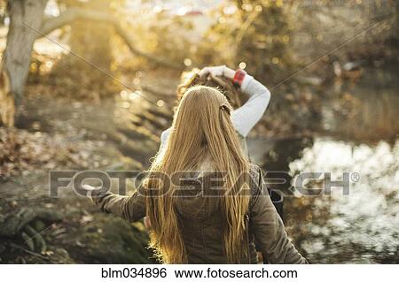 Stock Photograph - Caucasian women walking in park. Fotosearch