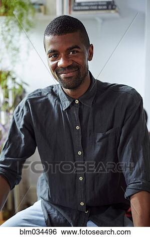 Stock Photograph - Close up of Black man smiling indoors. Fotosearch