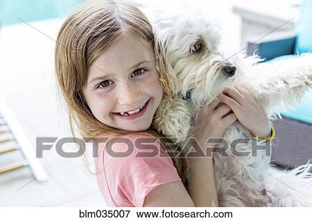 Close up of Caucasian girl hugging puppy View Large Photo Image Stock Photo - Close up of Caucasian girl hugging puppy. Fotosearch