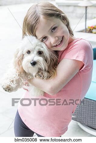 Close up of Caucasian girl hugging puppy View Large Photo Image Stock Photo - Close up of Caucasian girl hugging puppy. Fotosearch