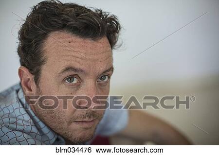 Stock Photograph - Close up of Caucasian man looking up. Fotosearch