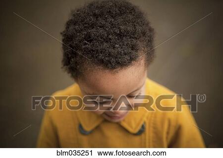 Stock Image - Close up of girl wearing yellow coat. Fotosearch