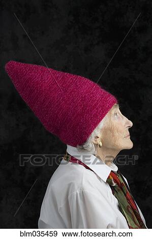 Close up of older woman wearing dunce cap View Large Photo Image Stock Photo - Close up of older woman wearing dunce cap. Fotosearch