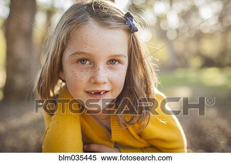 Close up of smiling girl laying in field View Large Photo Image Stock Photography - Close up of smiling girl laying in field. Fotosearch