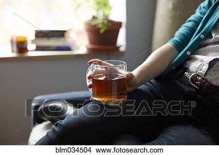 Picture - Close up of woman holding mug of tea. Fotosearch