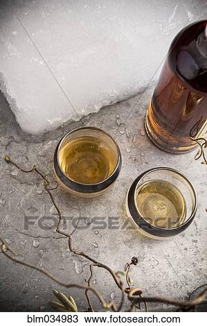 Cocktail glasses and ice block on table View Large Photo Image Stock Image - Cocktail glasses and ice block on table. Fotosearch