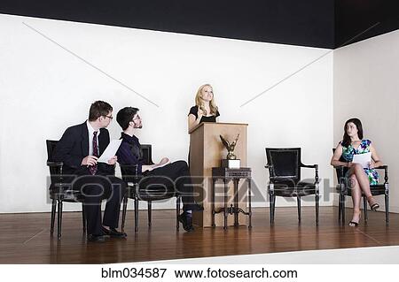 Stock Photo - Debate team speaking on stage. Fotosearch