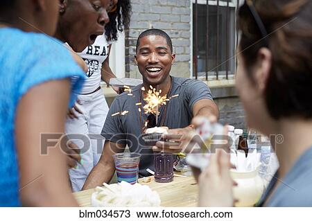 Friends celebrating birthday party in backyard View Large Photo Image Stock Image - Friends celebrating birthday party in backyard. Fotosearch