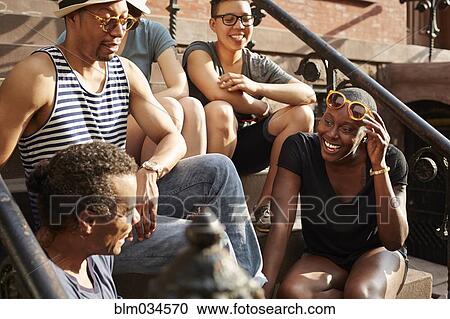 Friends relaxing on front stoop View Large Photo Image Stock Image - Friends relaxing on front stoop. Fotosearch