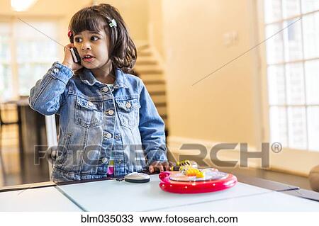 Stock Image - Girl talking on cell phone. Fotosearch