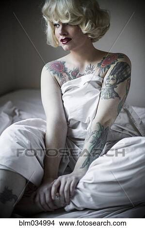 Glamorous woman wrapped in sheet on bed View Large Photo Image Picture - Glamorous woman wrapped in sheet on bed. Fotosearch
