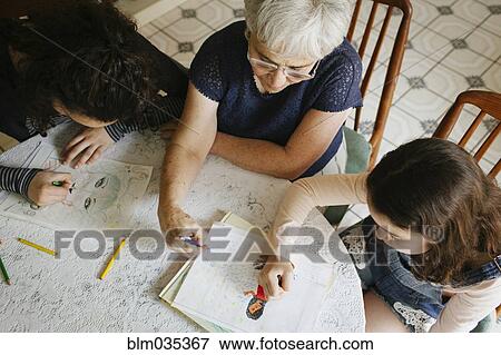 Grandmother and grandchildren drawing at table View Large Photo Image Stock Photo - Grandmother and grandchildren drawing at table. Fotosearch