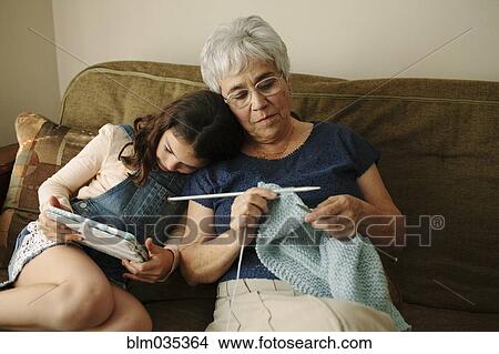 Grandmother and granddaughter relaxing in living room View Large Photo Image Picture - Grandmother and granddaughter relaxing in living room. Fotosearch