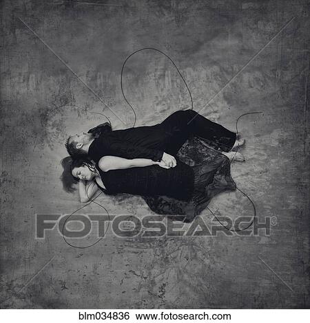 Stock Photograph - High angle view of sleeping couple holding hands. Fotosearch