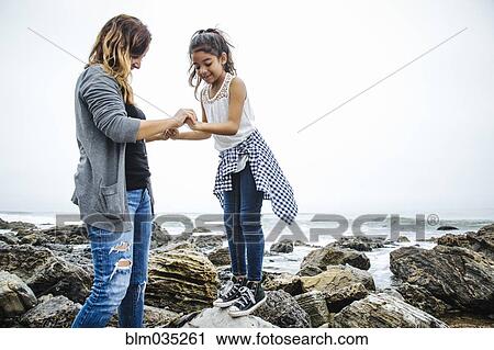 Hispanic mother and daughter exploring tide pools View Large Photo Image Stock Image - Hispanic mother and daughter exploring tide pools. Fotosearch