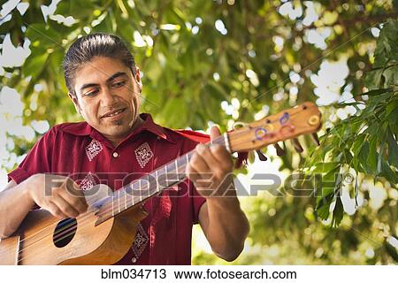 Hispanic musician performing in park View Large Photo Image Stock Image - Hispanic musician performing in park. Fotosearch