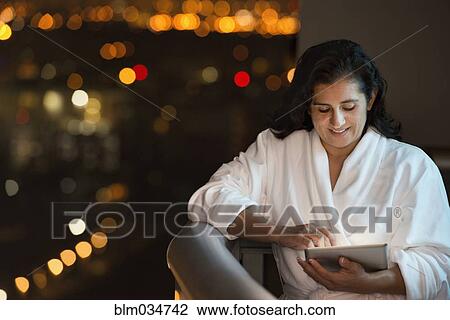 Hispanic woman using digital tablet on hotel balcony View Large Photo Image Stock Image - Hispanic woman using digital tablet on hotel balcony. Fotosearch