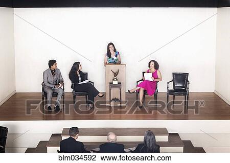 Judges listening to debate team speaking on stage View Large Photo Image Stock Image - Judges listening to debate team speaking on stage. Fotosearch