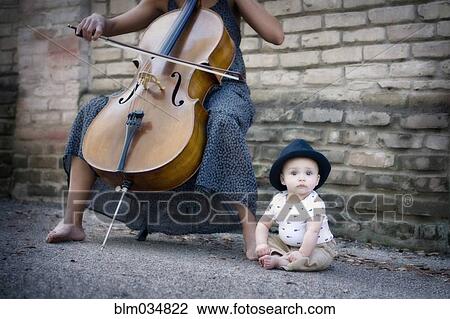 Mixed race musician playing cello with baby daughter View Large Photo Image Stock Image - Mixed race musician playing cello with baby daughter. Fotosearch