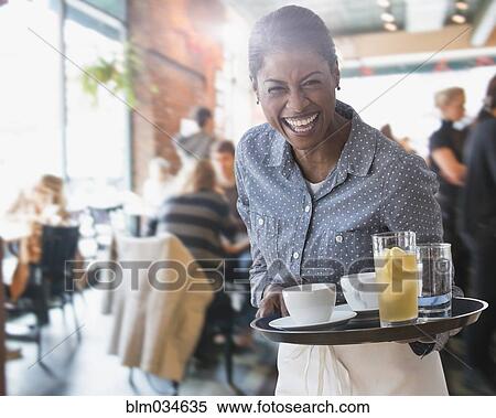 Mixed race waitress serving coffee and lemonade in cafe View Large Photo Image Stock Photography - Mixed race waitress serving coffee and lemonade in cafe. Fotosearch