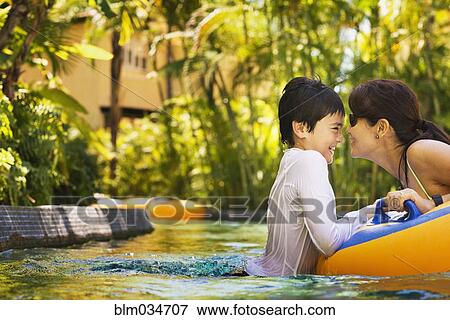 Mother and son swimming in pool View Large Photo Image Stock Photo - Mother and son swimming in pool. Fotosearch
