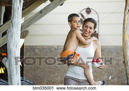 Mother carrying son in backyard View Large Photo Image Stock Image - Mother carrying son in backyard. Fotosearch