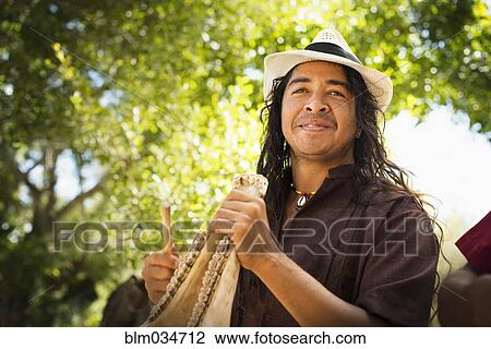 Stock Image - Musician performing in park. Fotosearch