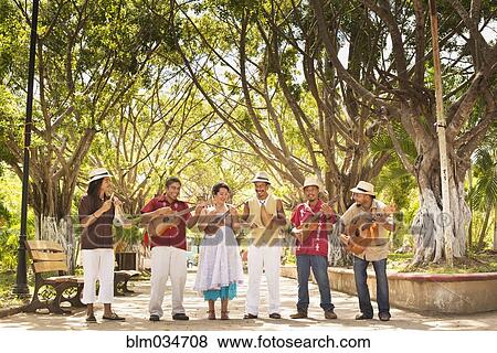 Musicians performing in park View Large Photo Image Stock Photo - Musicians performing in park. Fotosearch