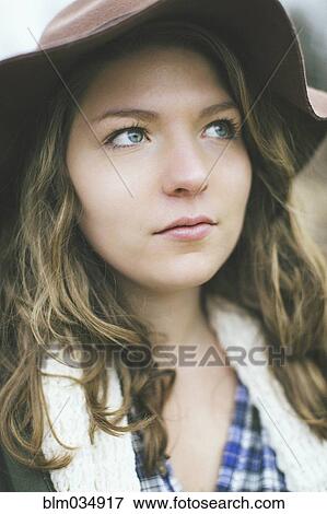 Pensive Caucasian woman wearing sun hat View Large Photo Image Stock Photo - Pensive Caucasian woman wearing sun hat. Fotosearch