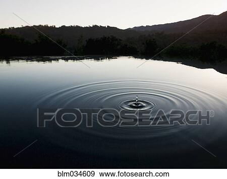 Ripple of water in still lake near mountains View Large Photo Image Stock Photo - Ripple of water in still lake near mountains. Fotosearch