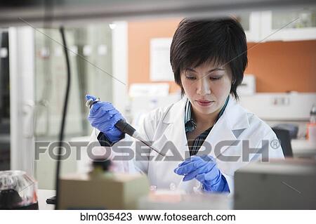 Scientist pipetting liquid into test tube in laboratory View Large Photo Image Stock Image - Scientist pipetting liquid into test tube in laboratory. Fotosearch