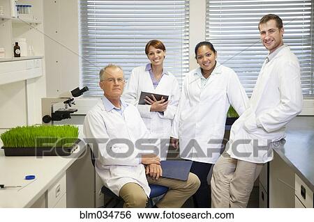Stock Photograph - Scientists posing in laboratory. Fotosearch