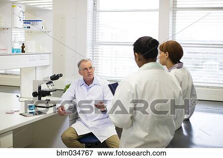 Stock Photo - Scientists talking in laboratory. Fotosearch