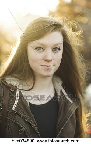 Stock Image - Smiling Caucasian woman with long hair. Fotosearch