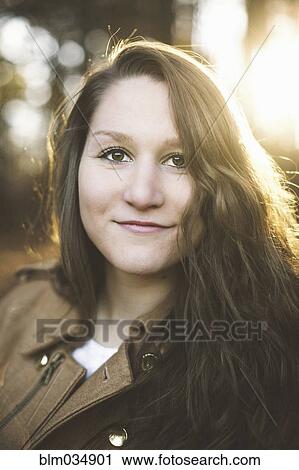 Stock Image - Smiling Caucasian woman with long hair. Fotosearch