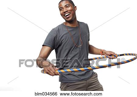 Stock Photograph - Smiling man playing with plastic hoop. Fotosearch