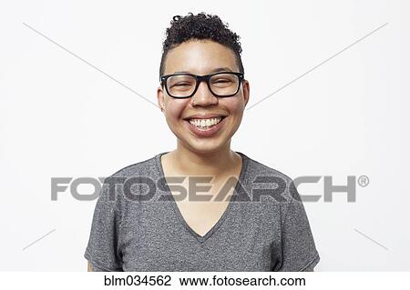 Stock Image - Smiling mixed race woman wearing eyeglasses. Fotosearch