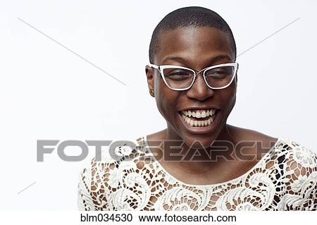 Stock Image - Smiling stylish woman wearing eyeglasses. Fotosearch