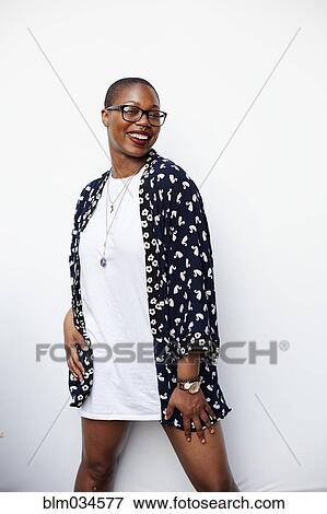 Stock Photo - Stylish Black woman posing in dress. Fotosearch