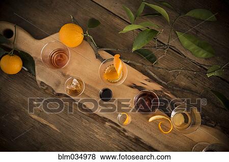 Stock Photo - Variety of cocktails on wooden board. Fotosearch