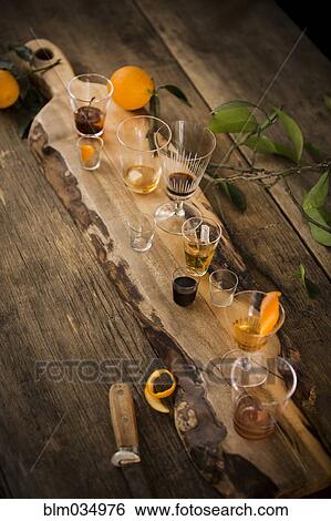 Stock Photograph - Variety of cocktails on wooden board. Fotosearch