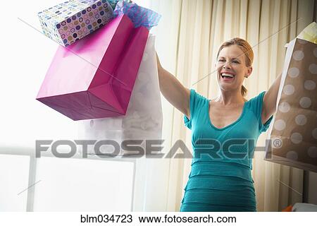 Woman holding shopping bags View Large Photo Image Stock Image - Woman holding shopping bags. Fotosearch