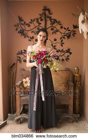 Woman in evening gown carrying bouquet of flowers View Large Photo Image Stock Photograph - Woman in evening gown carrying bouquet of flowers. Fotosearch