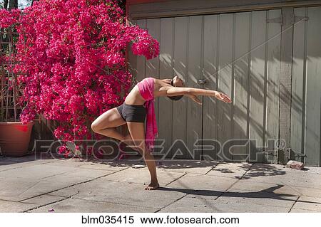 Woman practicing yoga near flowers and fence View Large Photo Image Stock Photography - Woman practicing yoga near flowers and fence. Fotosearch