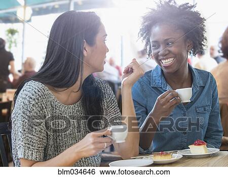 Women drinking coffee in cafe View Large Photo Image Stock Photograph - Women drinking coffee in cafe. Fotosearch